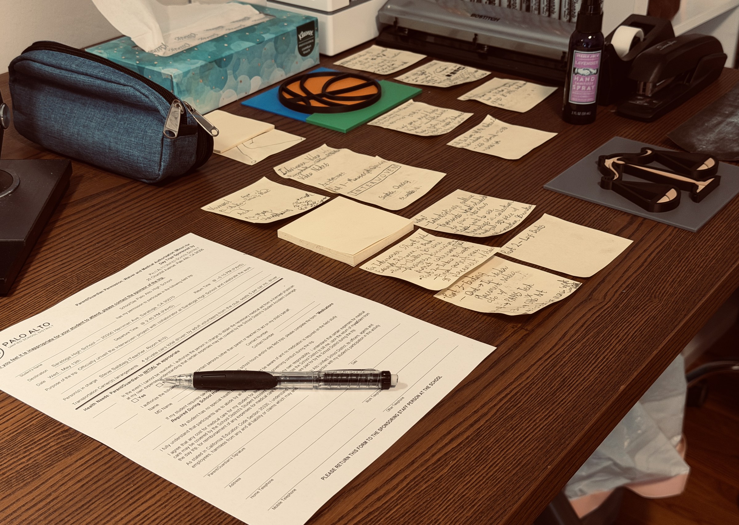 A worktable covered with sketches, notes, prototypes, and the tools used to shape a collaborative Art + Tech project.
